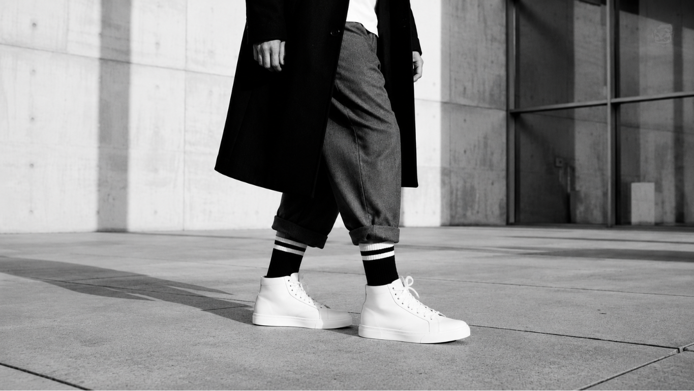 Cinematic photograph of a person walking in a minimal urban environment